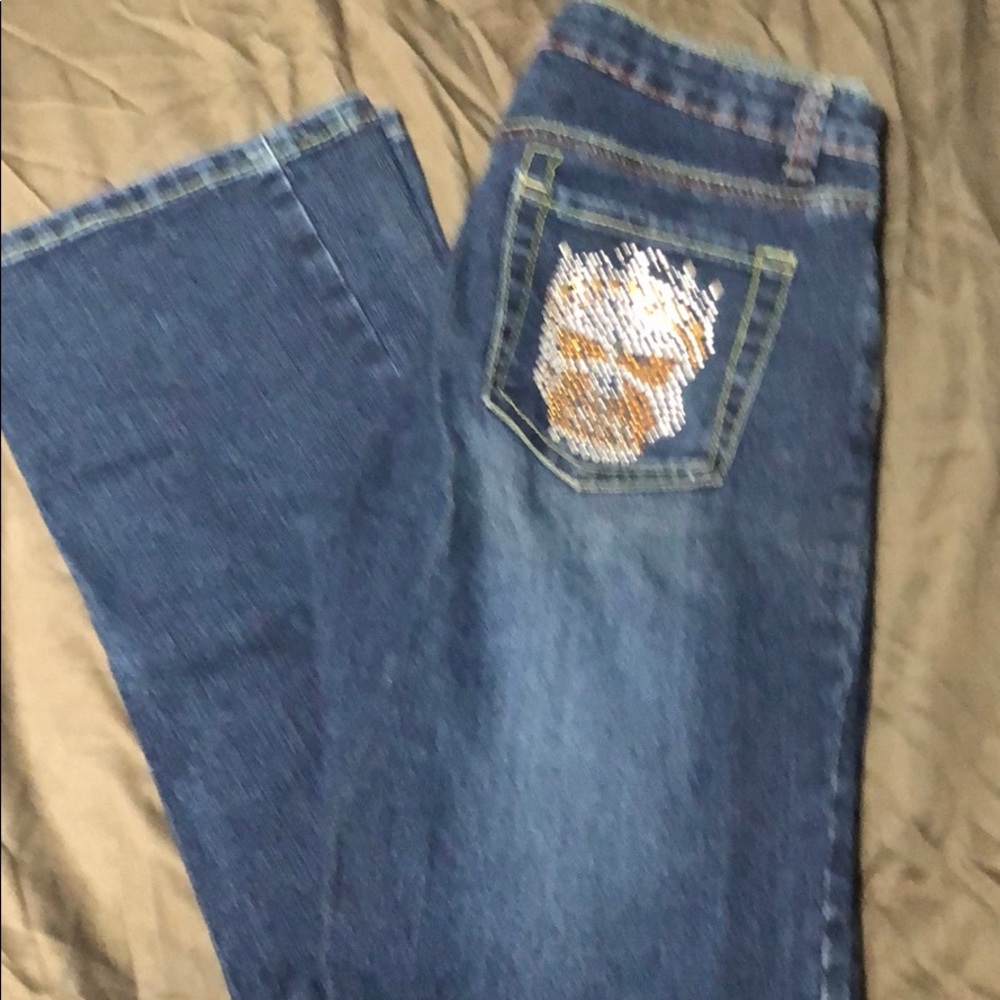 Denim jeans with jewelled skeleton on back pockets